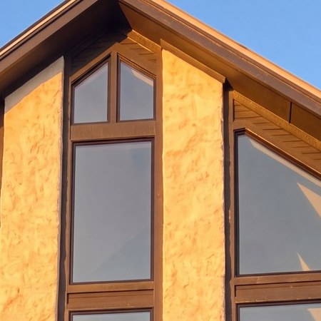 The finished gable window wall at golden hour — detail from the real Hill Country window-wall job.